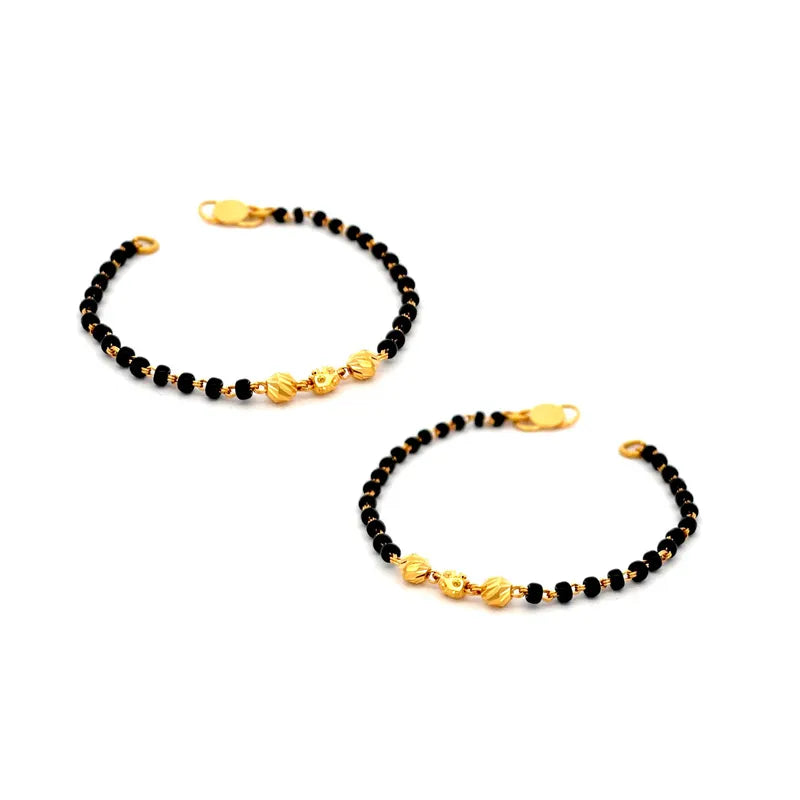 Elegant 22K yellow gold baby bracelet with classic black beads for little ones