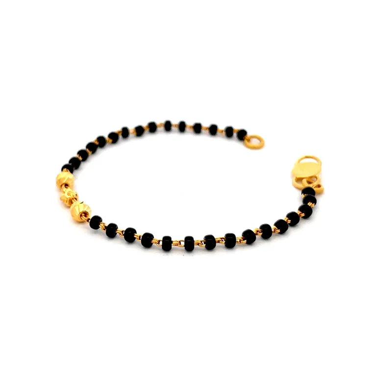 Elegant 22K yellow gold baby bracelet with classic black beads for little ones