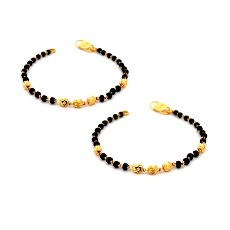 Beautiful 22K yellow gold baby bracelet with elegant black beads for a touch of charm