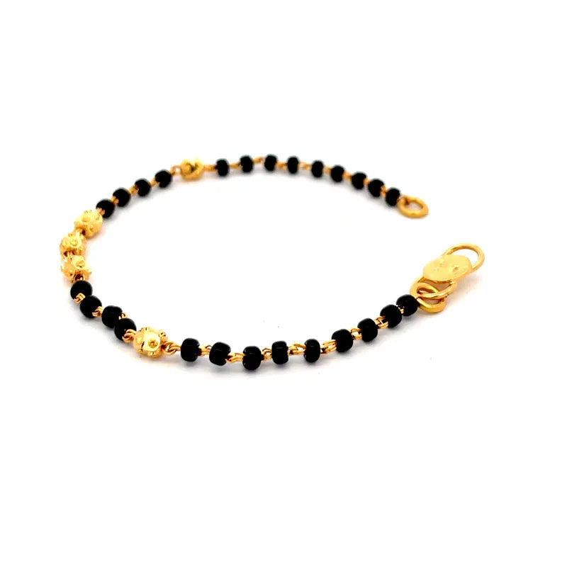 Beautiful 22K yellow gold baby bracelet with elegant black beads for a touch of charm
