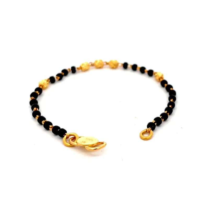 Beautiful 22K yellow gold baby bracelet with elegant black beads for a touch of charm