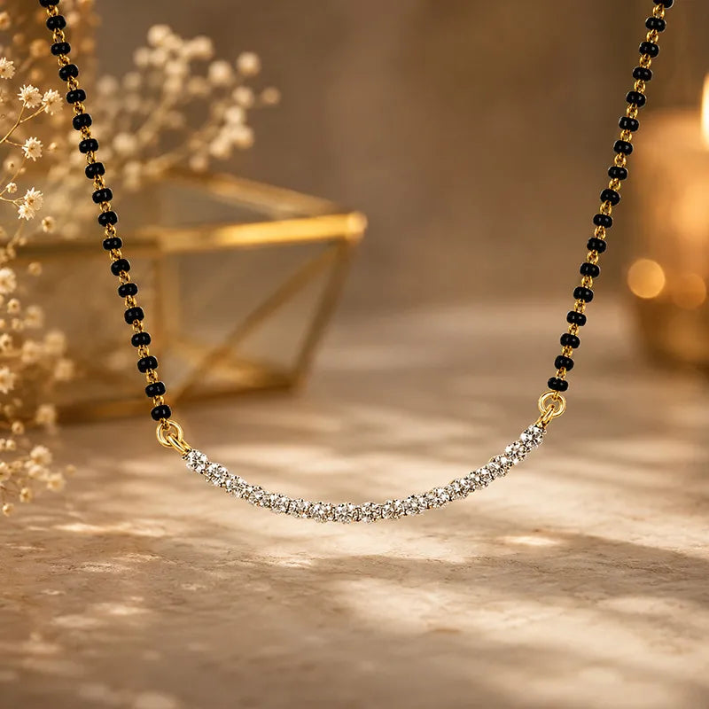 Elegant 18K gold mangalsutra with sparkling diamonds and black beads