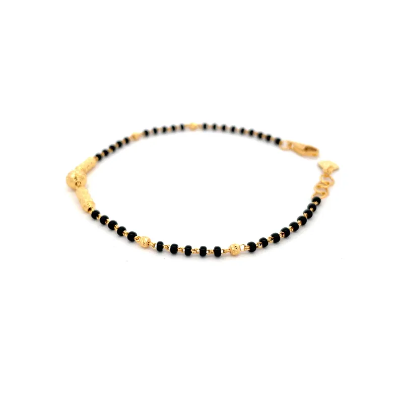 Elegant 22k yellow gold bracelet with contrasting black beads for a stylish look