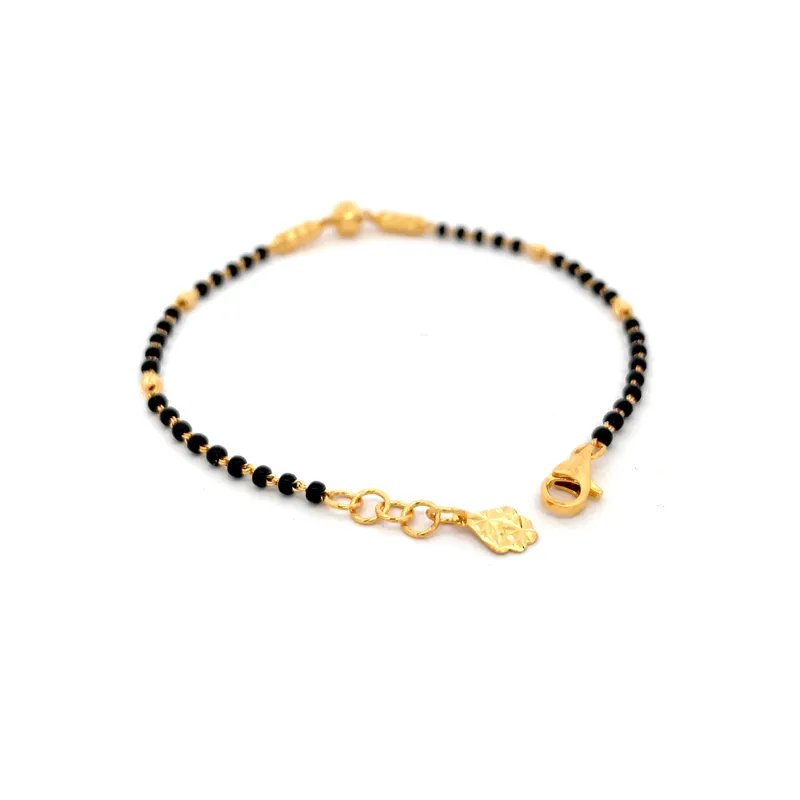 Elegant 22k yellow gold bracelet with contrasting black beads for a stylish look