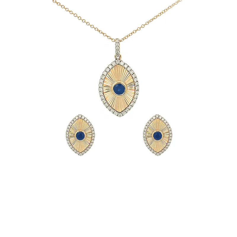 Oval sapphire pendant and matching earrings set in lustrous 18K yellow gold with diamond accents